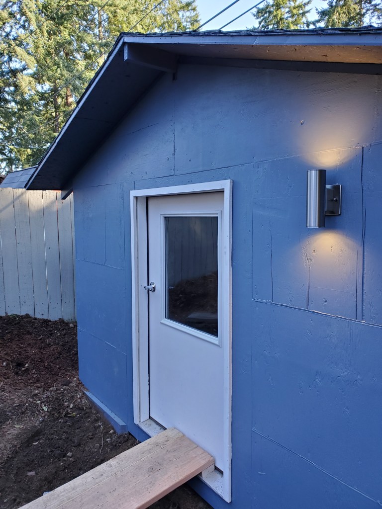 front of shed with door and new exterior light